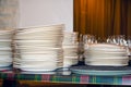 Clean white plates stacked on table Royalty Free Stock Photo