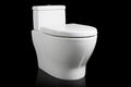 A clean white porcelain toilet home fixture isolated on black background