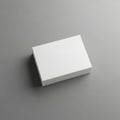 A clean white rectangular box rests on a neutral gray surface in a studio setting Royalty Free Stock Photo