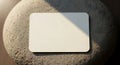 Blank White Card Resting on Textured Surface Under Dramatic Lighting Royalty Free Stock Photo