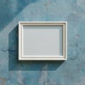 Blank White Photo Frame on Textured Blue Wall with Shadow Royalty Free Stock Photo