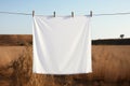 Clean white sheet drying on a line. Laundry with clothes pins on a rope outdoors. Clean clothesline dry laundry line. Empty space