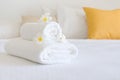 Clean white spa towels and flowers in blurred bedroom interior Royalty Free Stock Photo