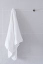 Clean white towel hanging on wall in bathroom Royalty Free Stock Photo