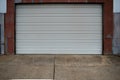 Clean white warehouse rolling door of old storage building Royalty Free Stock Photo