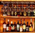 Clean wine glasses on the background of the bar with bottles of various alcoholic beverages.