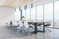 Clean wooden and concrete meeting room interior with panoramic city view, daylight and large table with chairs. Corporate design Royalty Free Stock Photo