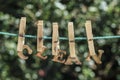 CLEAN word written by hanged wooden letters on rope at garden