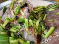 A cleaned grouper fish is prepared with black beans and some home ingredients is ready to steam.