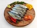 Ready to cook Fresh Fish Horse / Indian Mackerel Fish Decorated with herbs and Vegetables on a wooden pad Royalty Free Stock Photo