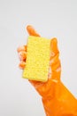 Cleaner concept, Hand in orange rubber gloves and holding yellow sponge with foam for cleaning Royalty Free Stock Photo