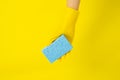 Cleaner concept, Hand in rubber gloves and holding light blue sponge for cleaning in home Royalty Free Stock Photo