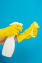 Cleaner concept, Hand in rubber gloves and holding spray bottle to spray cleaner on yellow sponge Royalty Free Stock Photo