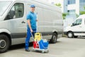 Cleaner In Front Of Van With Cleaning Equipments