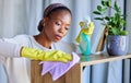 Cleaner, house and black woman cleaning dust on furniture, tables and wood with liquid soap in spray bottle and cloth Royalty Free Stock Photo