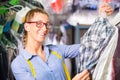 Cleaner in laundry shop checking clean clothes