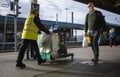 Cleaner from LNER London North Eastern Railway walking with trolley.