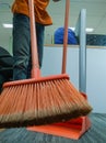 Cleaner in office sweeping the floow using Nylon broom