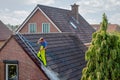 Cleaner with pressure washer at roof house cleaning roof tiles