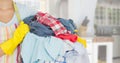 CleanerMid section of woman with apron holding a laundry basket Royalty Free Stock Photo