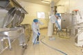 Cleaners cleaning industrial kitchen floor Royalty Free Stock Photo