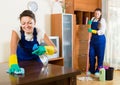 Cleaners cleaning in room