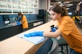 Cleaners in a coworking area cleaning and disinfecting work surfaces Royalty Free Stock Photo