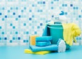 Cleaners and detergents in bucket, accessories for cleaning various surfaces and rooms blue background Royalty Free Stock Photo