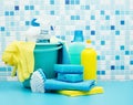 Cleaners and detergents in bucket, accessories for cleaning various surfaces and rooms blue background Royalty Free Stock Photo