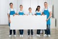 Cleaners holding banner in office Royalty Free Stock Photo