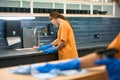 Cleaners in protective gloves clean and disinfect surfaces in kitchen area Royalty Free Stock Photo