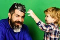 Cleaning activities concept. Man with beard and smiling child plays with soap suds. Royalty Free Stock Photo