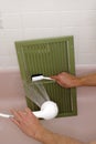 Cleaning an Air Return Vent Royalty Free Stock Photo