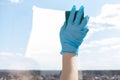 Cleaning of apartments, offices, cottages, warehouses, garages. Female hand washes a window with a sponge