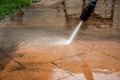 Cleaning backyard paving tiles with pressure washer Royalty Free Stock Photo