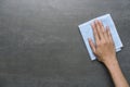 Cleaning black table by woman hand