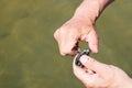 Cleaning blue mussel with bare hands and small knife above water