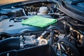 Cleaning the car engine with green microfiber cloth Royalty Free Stock Photo