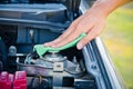 Cleaning the car engine with green microfiber cloth Royalty Free Stock Photo