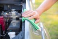 Cleaning the car engine with green microfiber cloth Royalty Free Stock Photo