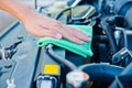 Cleaning the car engine with green microfiber cloth Royalty Free Stock Photo