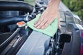 Cleaning the car engine with green microfiber cloth Royalty Free Stock Photo