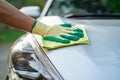 Cleaning car with green color microfiber cloth outdoor Royalty Free Stock Photo