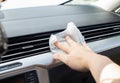 Cleaning the car interior with modern wet wipes against dust and dirt. Close-up Royalty Free Stock Photo