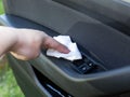 Cleaning the car interior with modern wet wipes against dust and dirt. Close-up Royalty Free Stock Photo