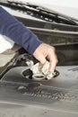Cleaning car motor cover after adding oil Royalty Free Stock Photo