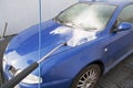 Cleaning of a car with water and soap in carwash