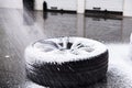 Cleaning car wheel and tire with active foam Royalty Free Stock Photo