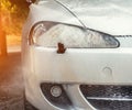 Cleaning cars headlight with steam radiator at car wash Royalty Free Stock Photo