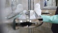 Cleaning chrome-plated bathrooms, bidets. polishing crane and handles. Cleaning in hotel. Close-up shot of maid from